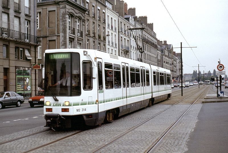 A TFS tram with two high-floor cars, branded TAN and running on line 1 towards Bellevue