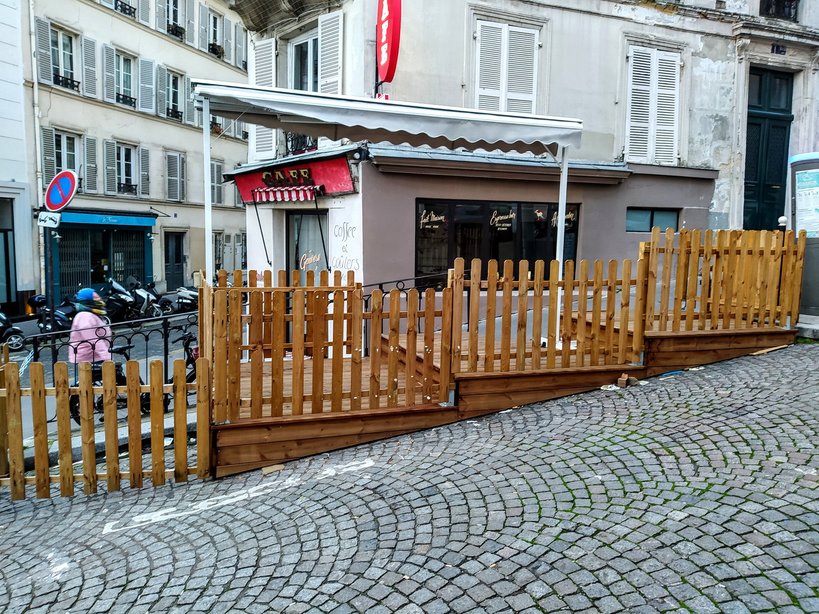 Tiered wooden structure outside a café