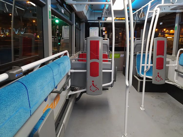 Bus interior with two wheelchair spaces and USB charging points