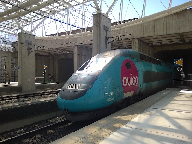 Blue and pink Ouigo high-speed train on platform