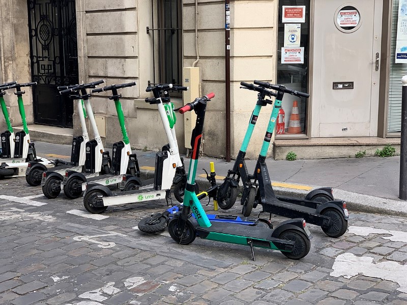 Lime, Dott and TIER e-scooters parked in a bay marked for them