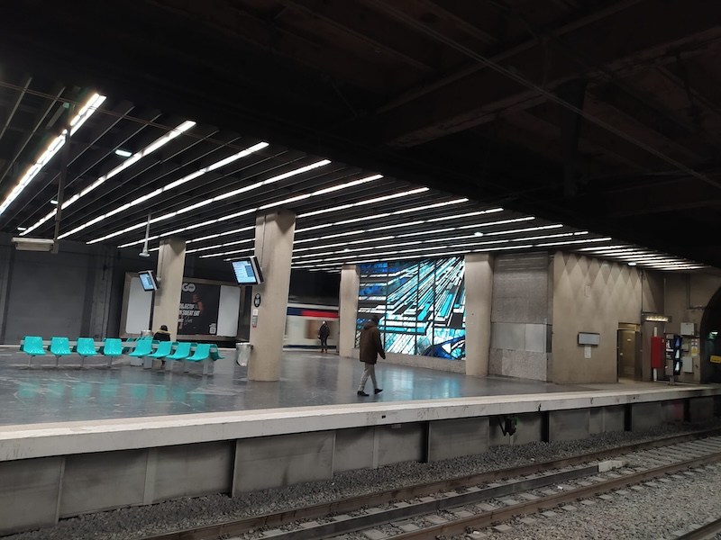 RER platform with turquoise seating and stained glass