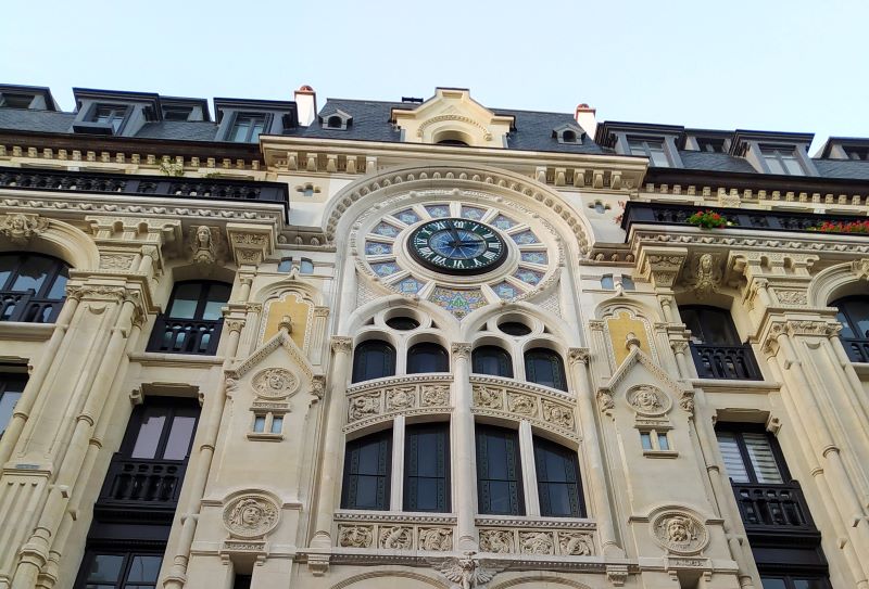 Close-up of clock on neogothic building façade