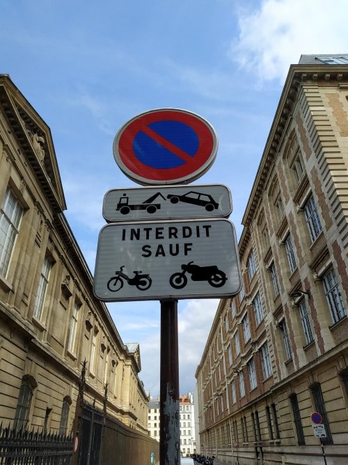 No parking sign warning that all vehicles except motorbikes and scooters will be towed