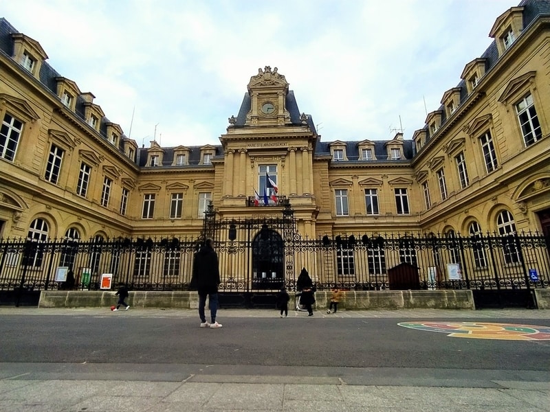 A city hall building with a traffic-free street in front