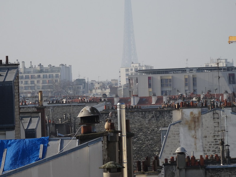Paris rooftops. The Eiffel Tower, though nearby, is only faintly visible