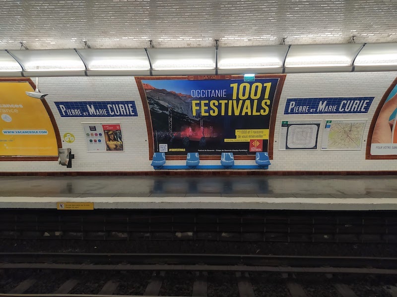 Metro station platform with lettering reading PIERRE ET MARIE CURIE