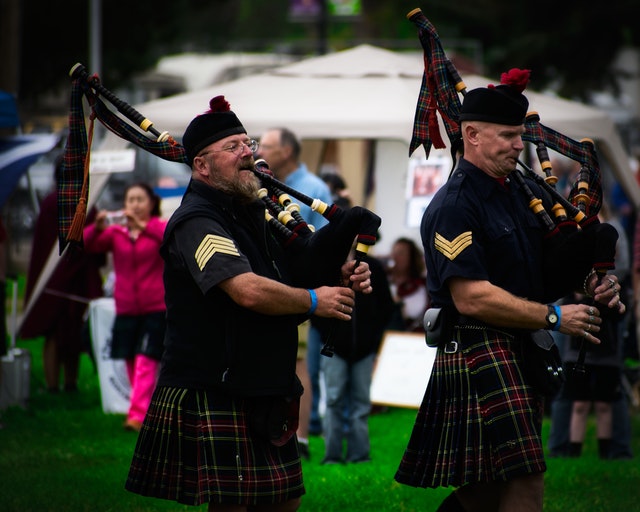 Two men playing bagpipes