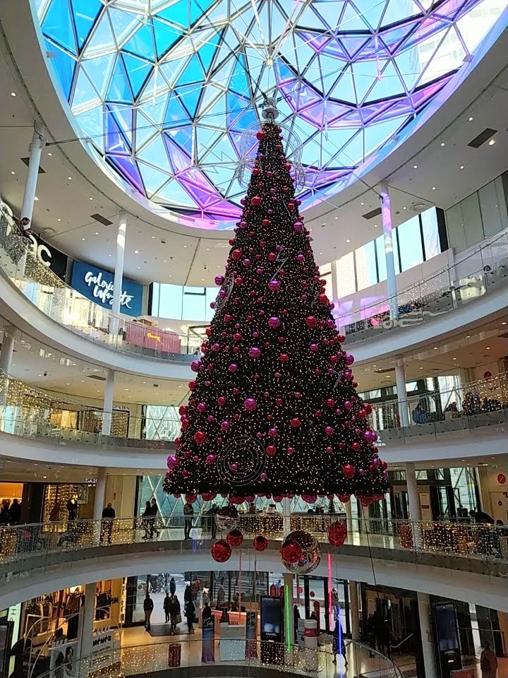 Suspended Christmas tree in the open space of a modern shopping centre building