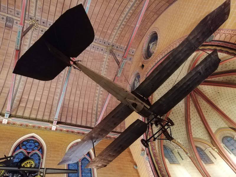 A plane suspended from the ceiling of a church, shot from below