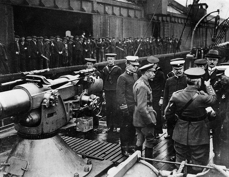 Black and white photograph of men in military uniforms aboard a ship