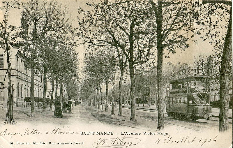 Postcard depicting double-decker tram on tree-lined street. Caption: Saint-Mandé – L'Avenue Victor Hugo
