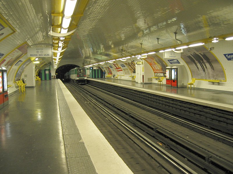 Metro platforms with a departing train