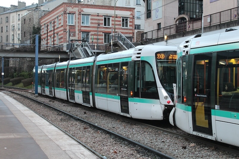 Modern low-floor tram in a station. One 5-car unit is visible, coupled with another unit of which we can see part of one car